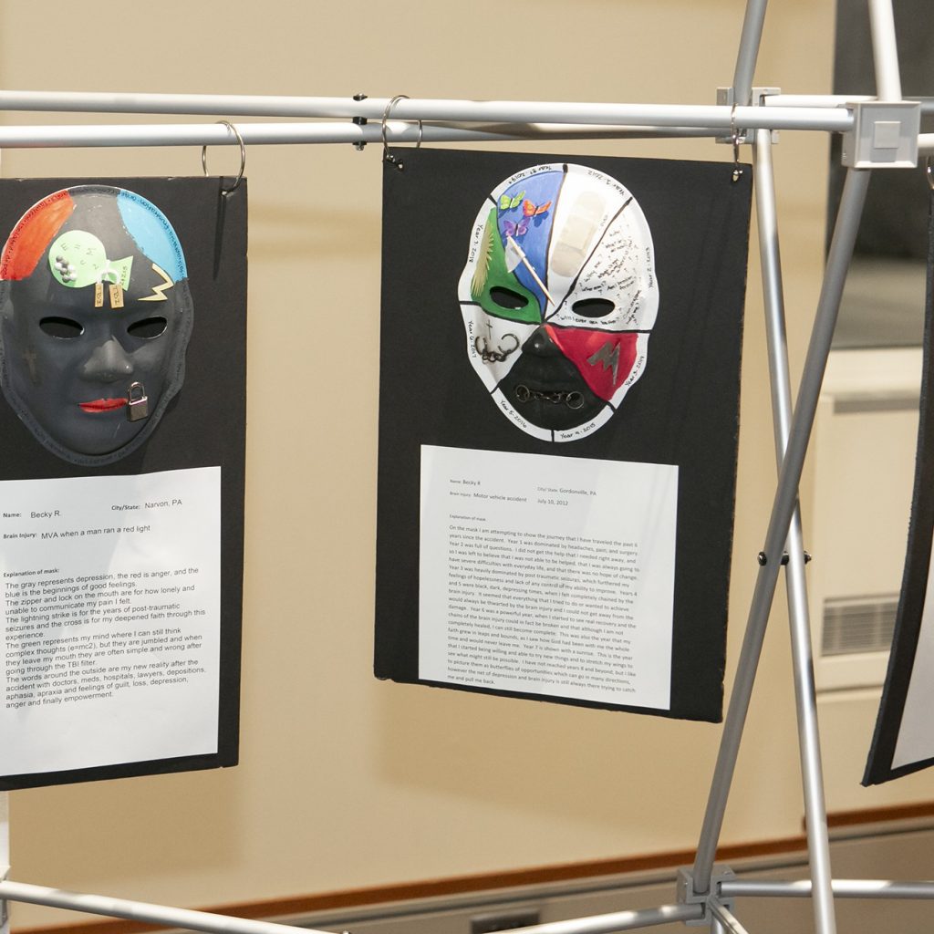 Two masks created during the Unmaking Brain Injury project segment of the conference.